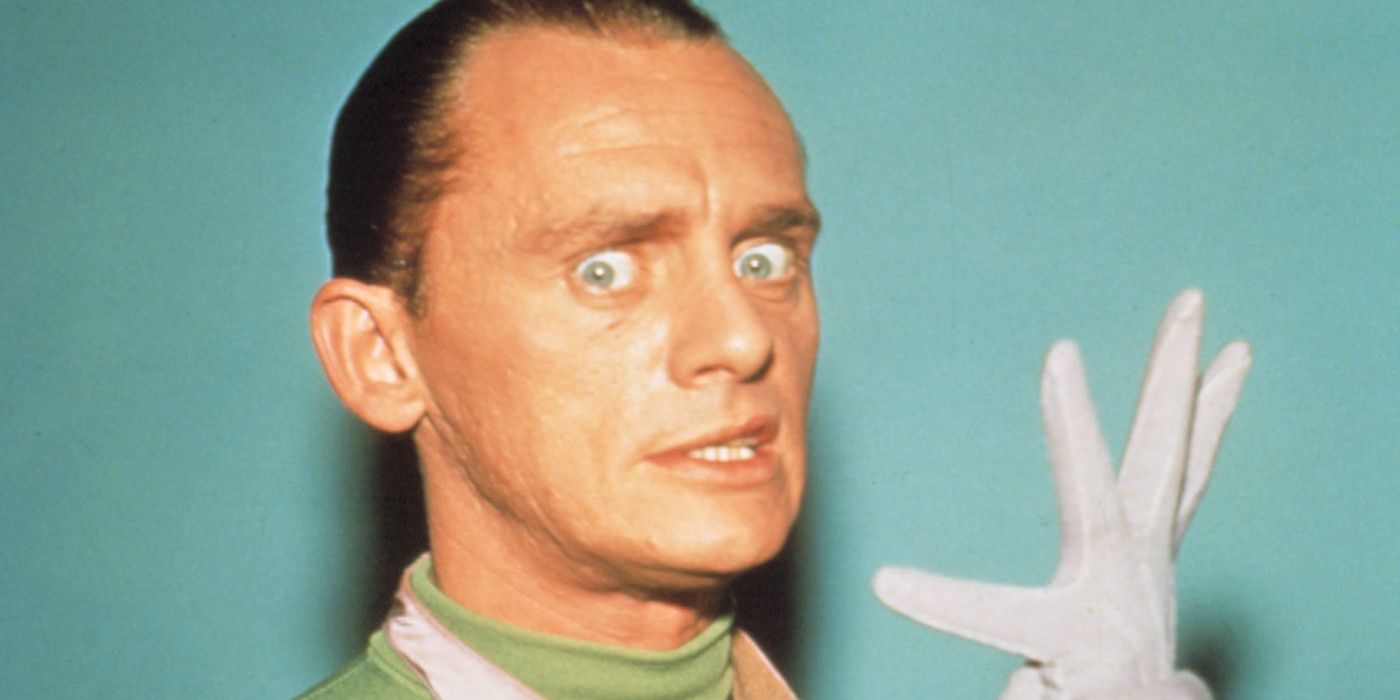 Frank Gorshin poses with one hand up from Batman