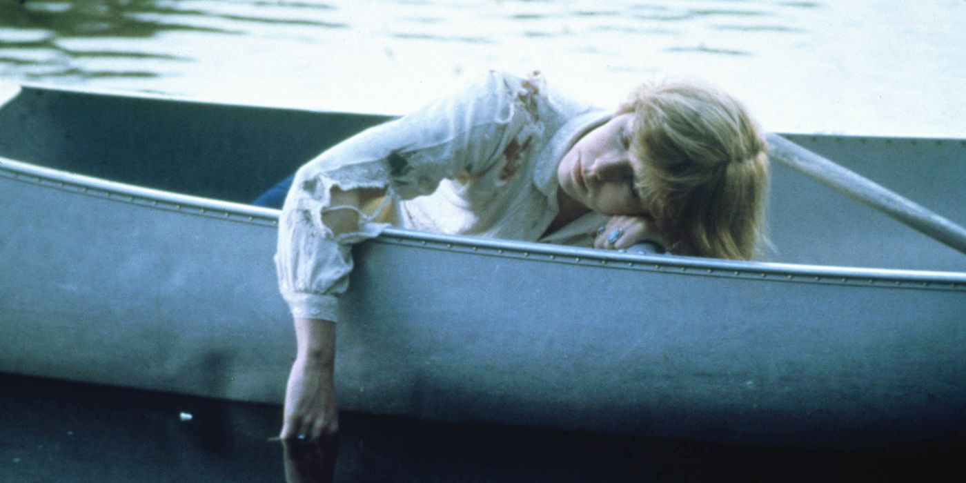 Alice resting her head on the ledge of the boat as it floats on the water