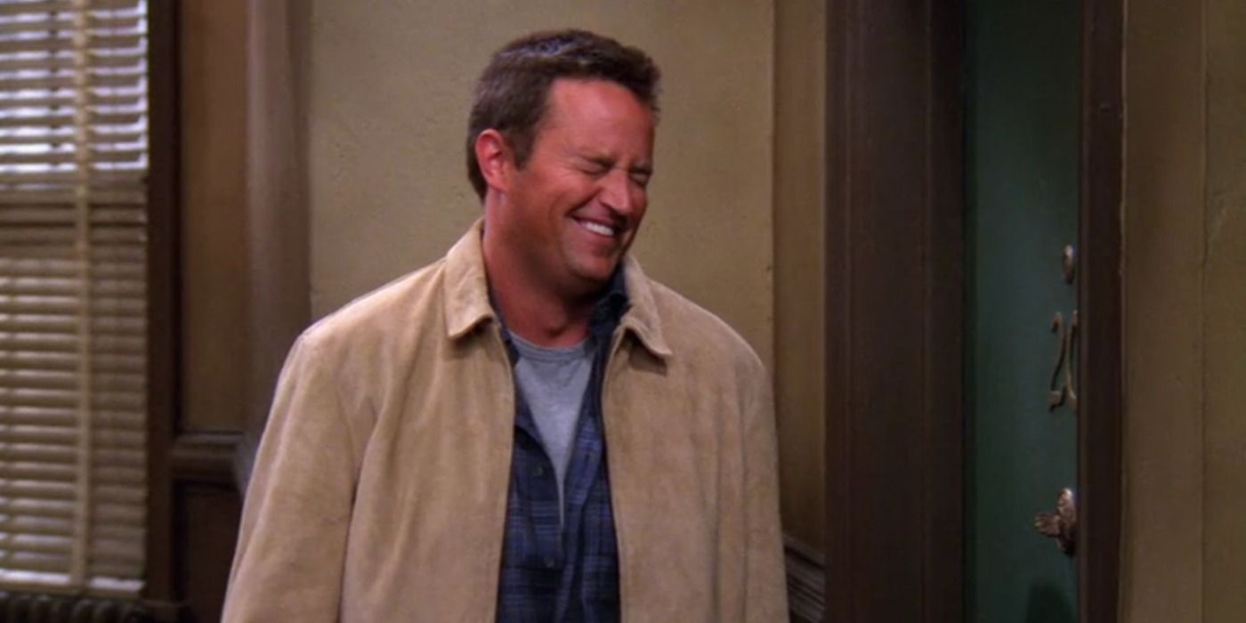Chandler laughing outside his apartment in Friends