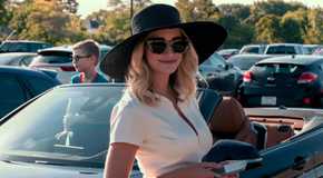 Georgia Miller from Ginny & Georgia Smiles Towards the camera as she stands in front of her car