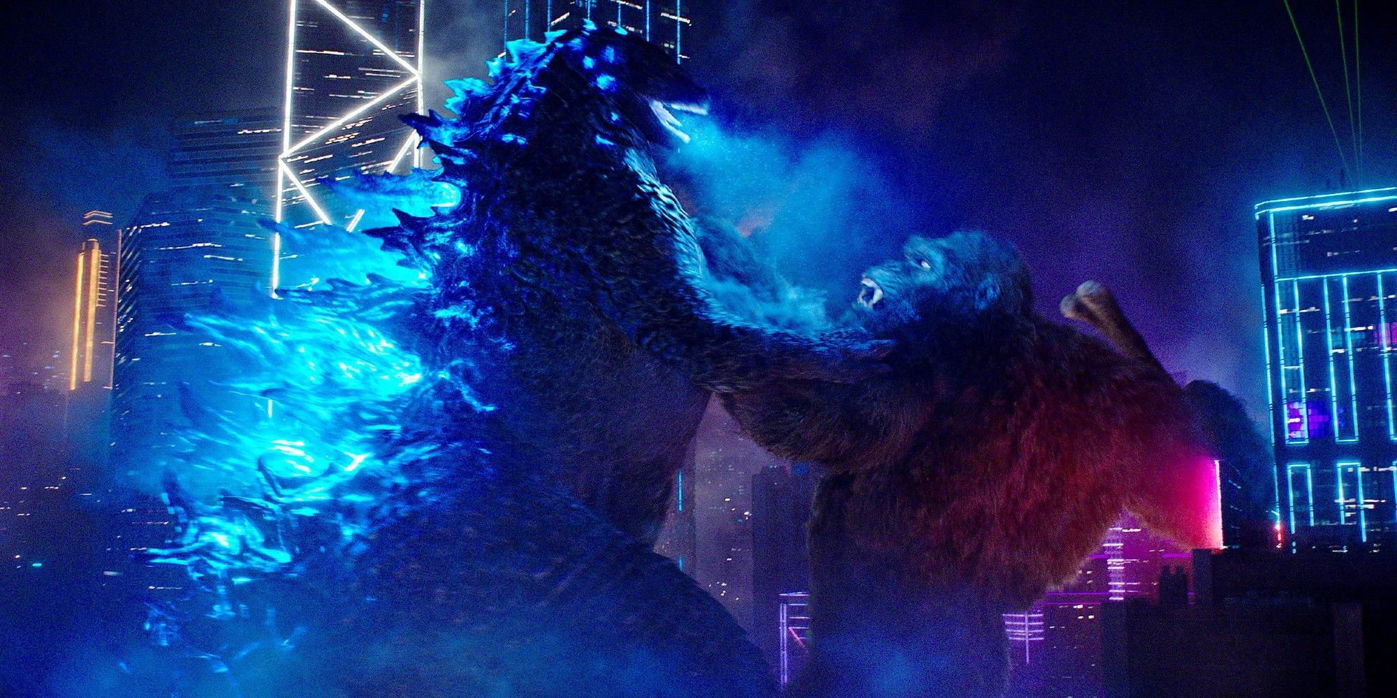Godzilla fighting Kong in Hong Kong at night