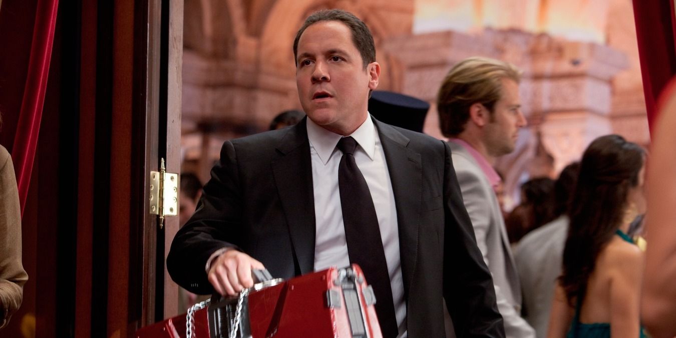 Happy Hogan carrying the suit