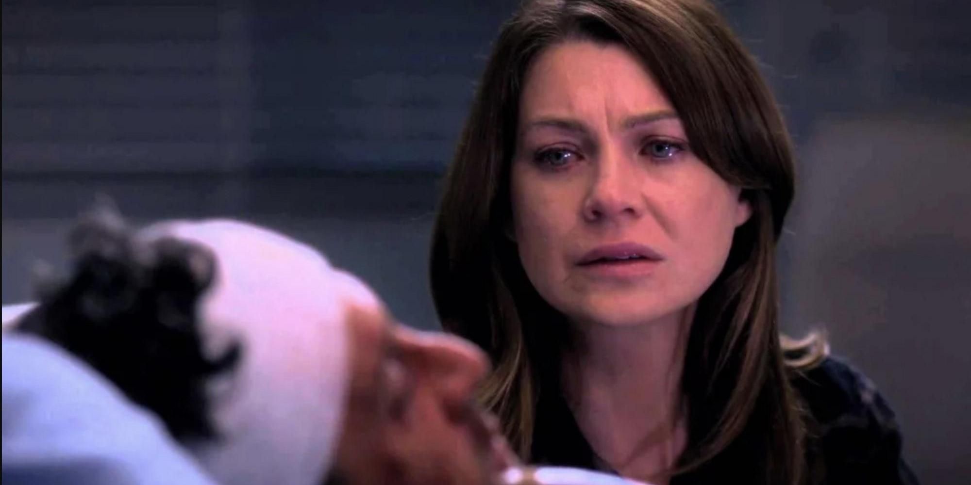 Meredith looks at Derek injured in a hospital bed in Grey's Anatomy