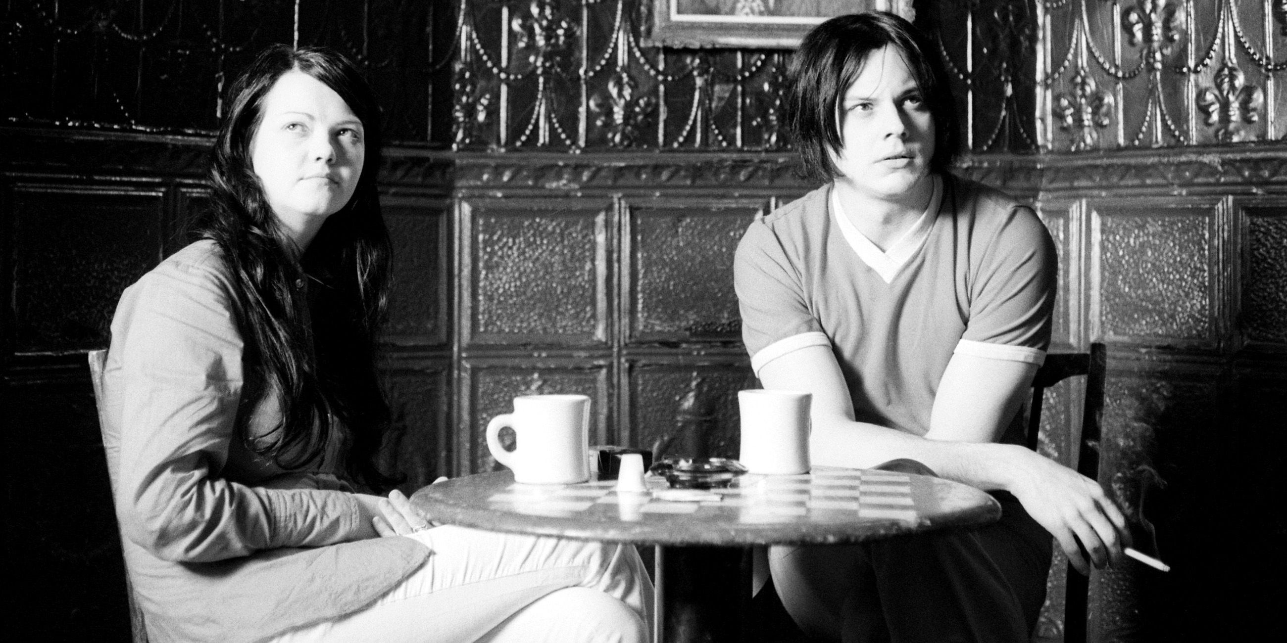 Jack and Meg White having coffee on a table in Coffee and Cigarettes.