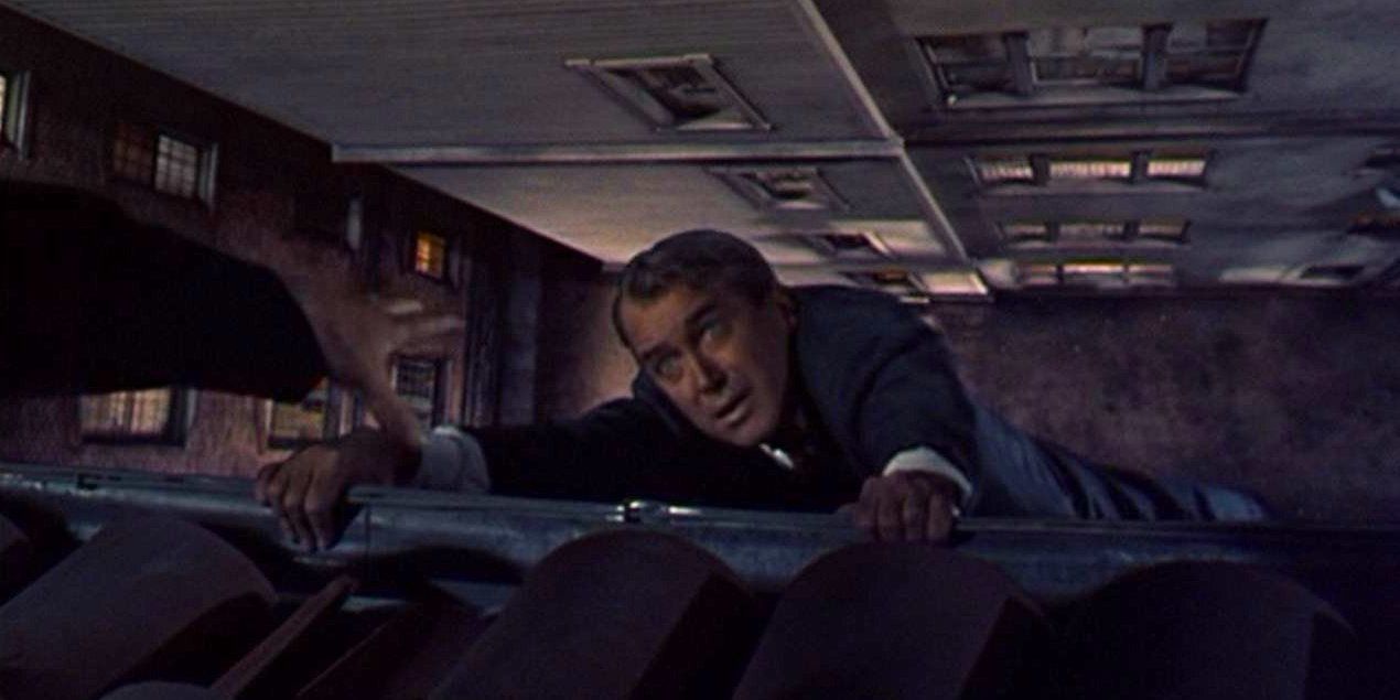 James Stewart hanging off the edge of the roof in the opening scene of Vertigo (1958)