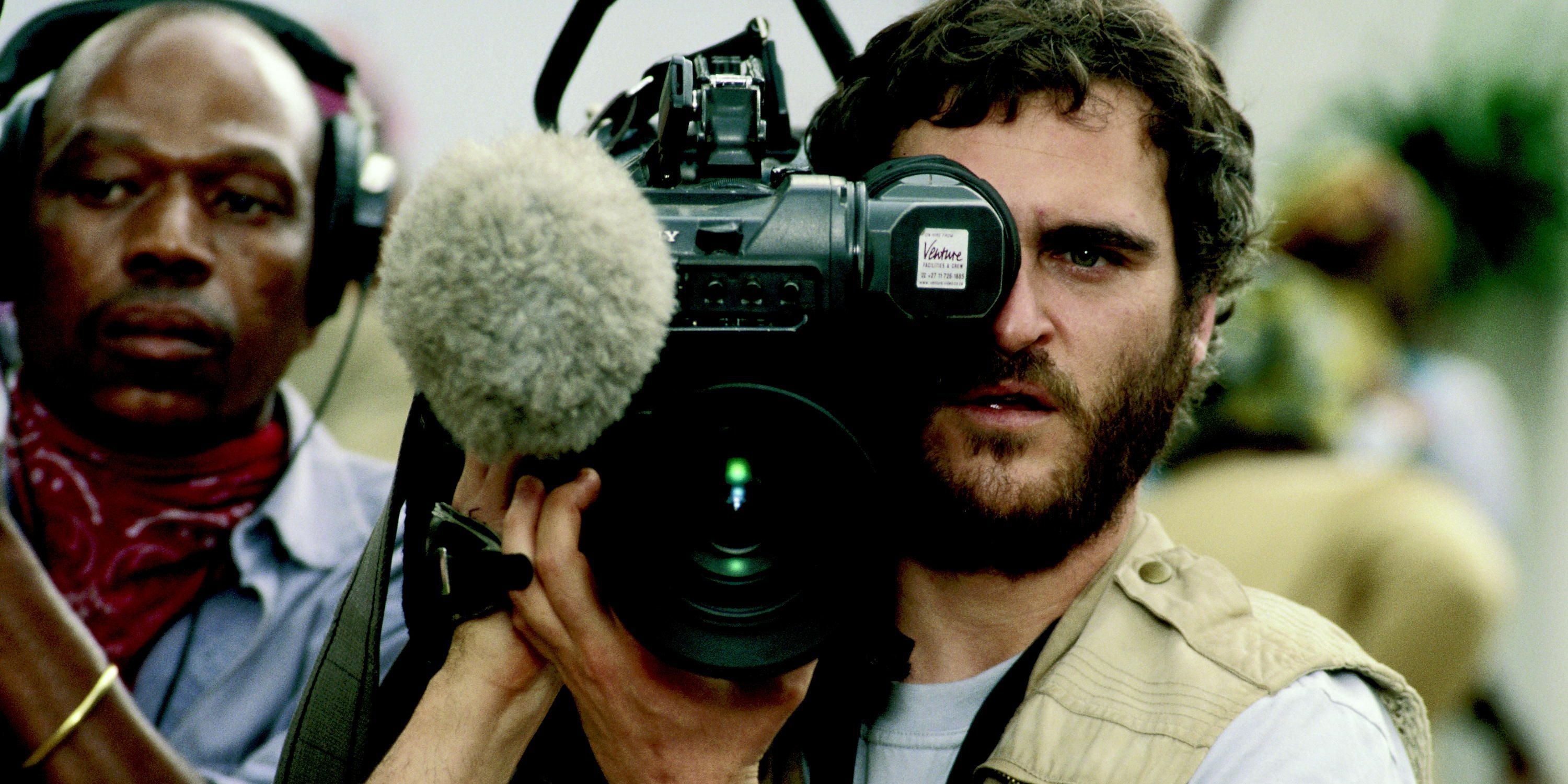 Joaquin Phoenix filming with a camera in Hotel Rwanda