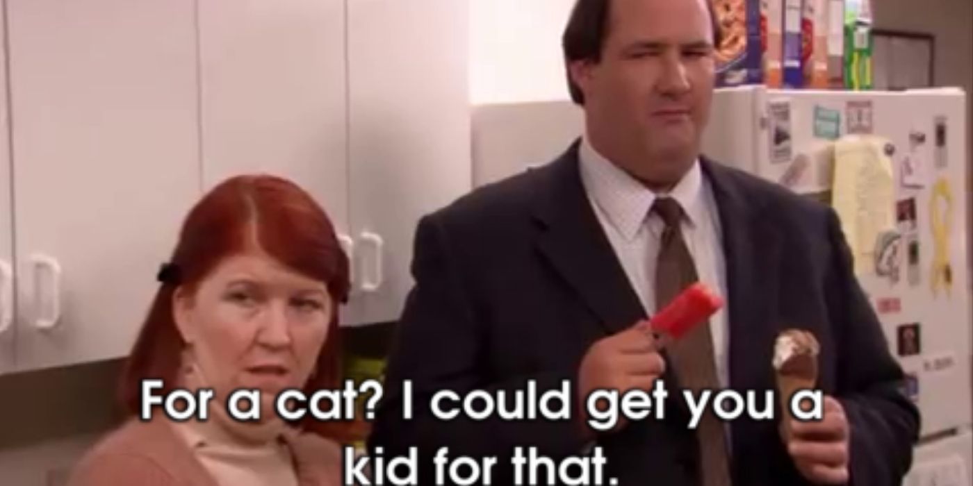 Kevin and meredith stand in the kitchen with creed on the office