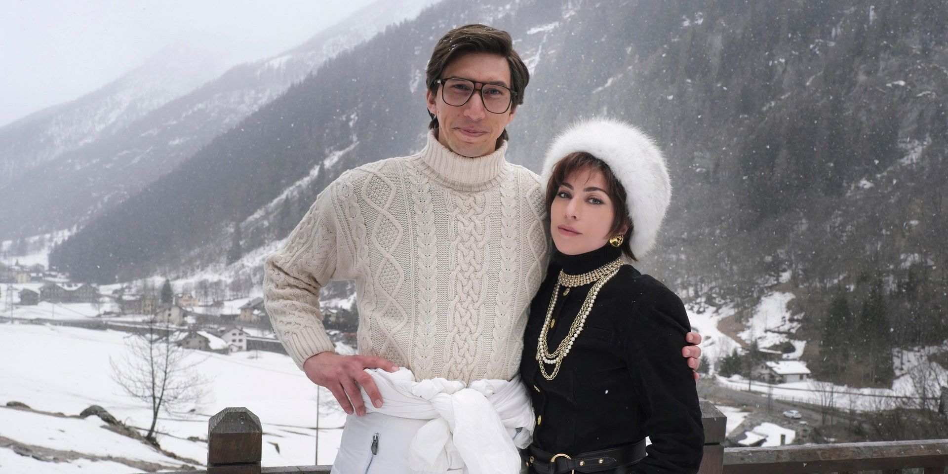 Lady Gaga And Adam Driver In House Of Gucci wearing winter clothing with a snowy background