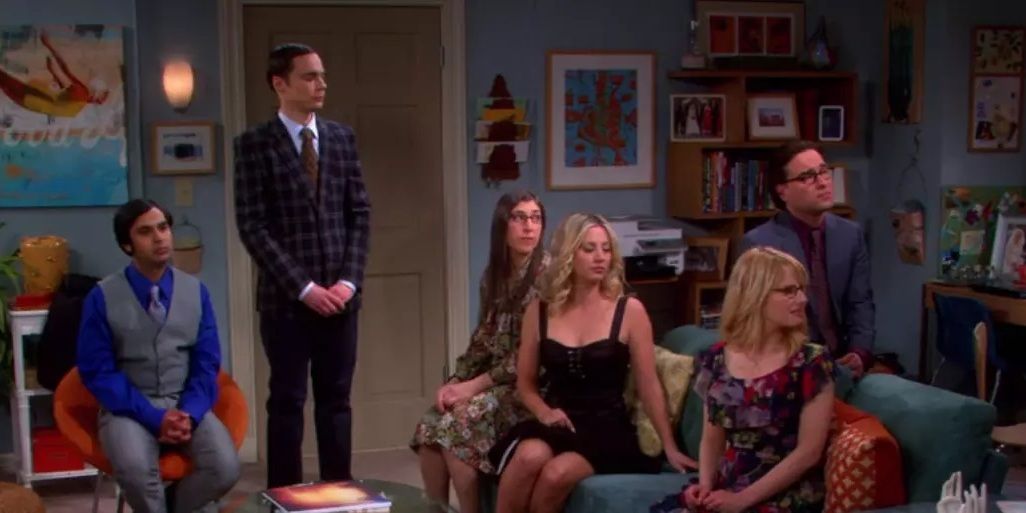 Gang sits stoically in Howard and Bernadette's living room in The Big Bang Theory