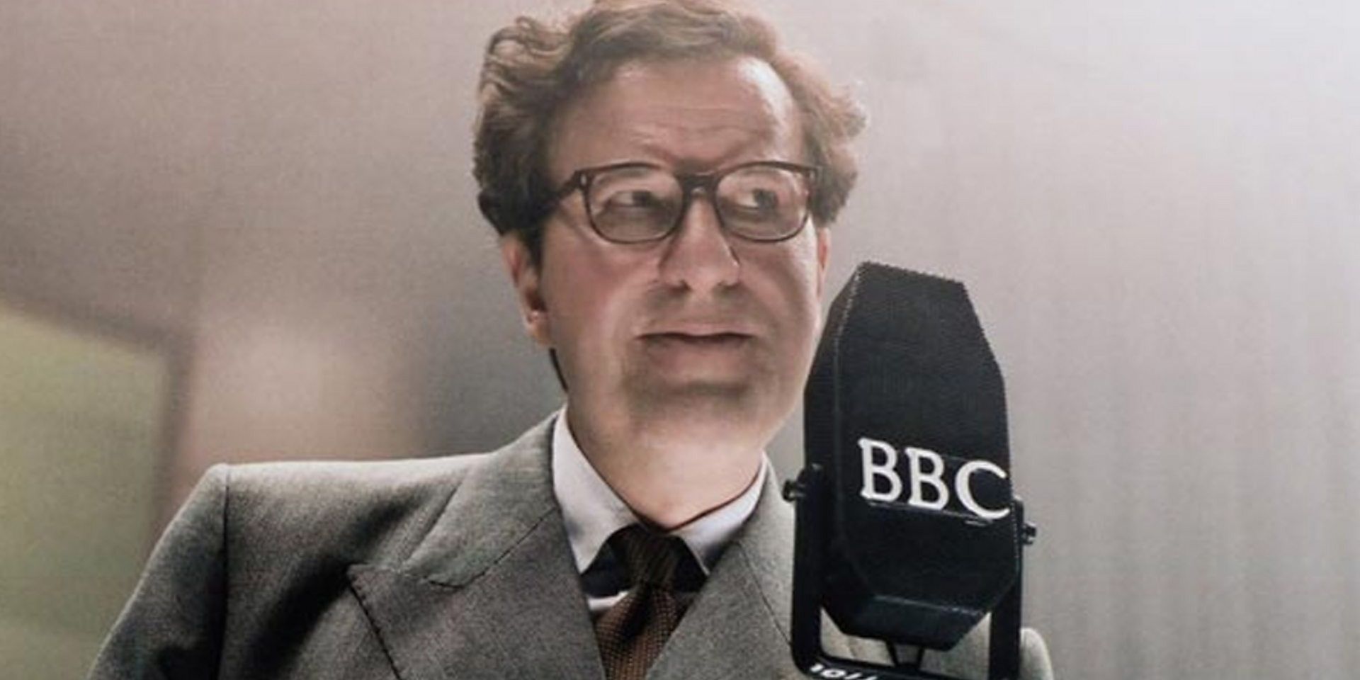 Geoffrey Rush as Peter Sellers standing behind microphone in the Life and Death of Peter Sellers