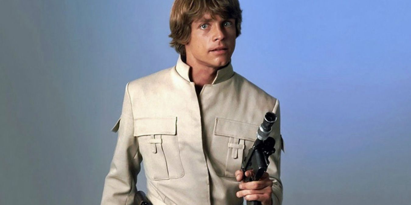 Luke Skywalker standing with his gun in his pilot uniform