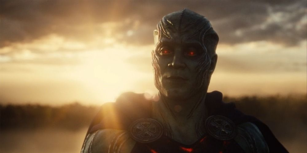 Martian Manhunter looking at Bruce Wayne at the end of Zack Snyder's Justice League with the sun behind him