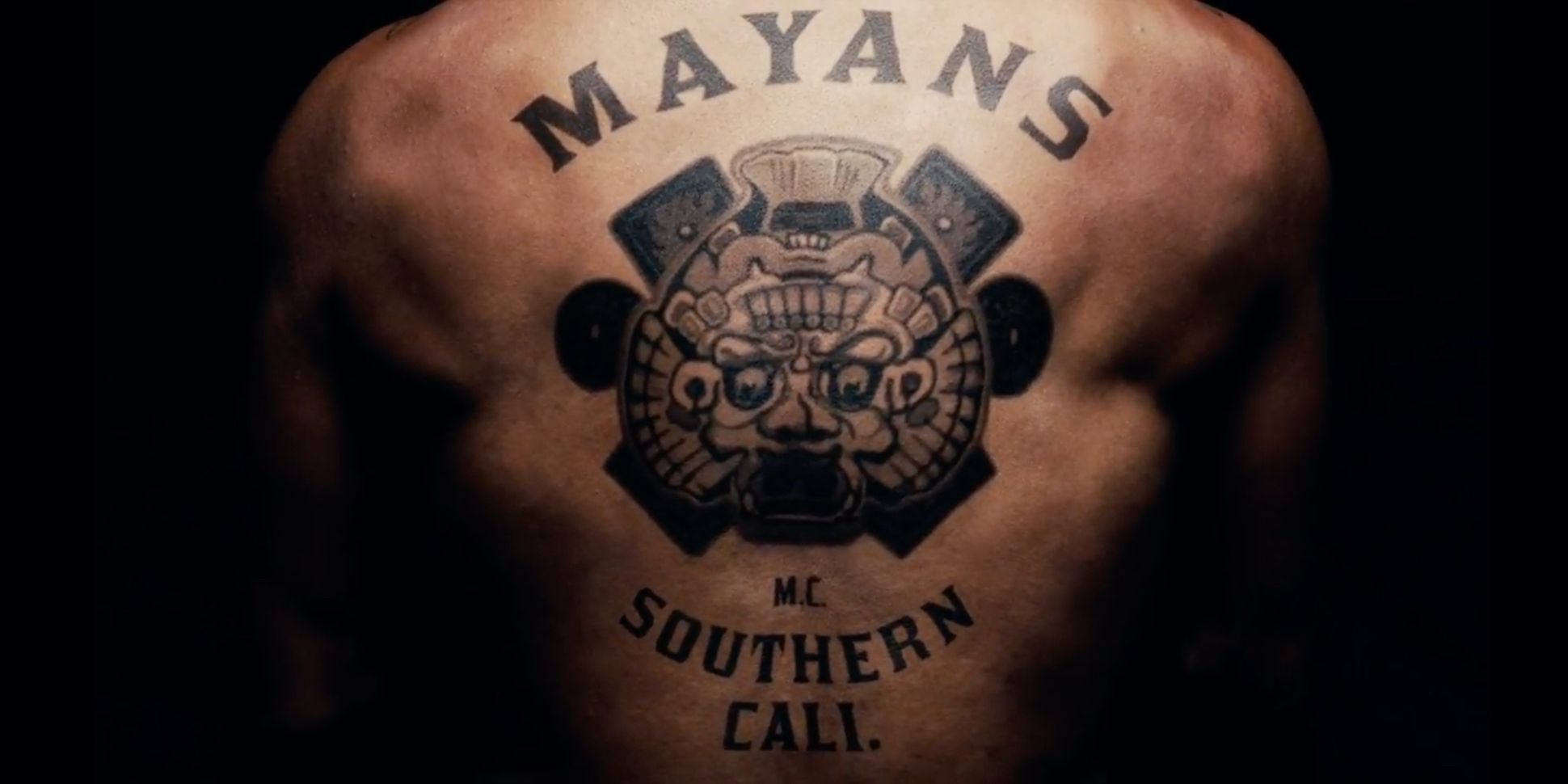 A man's back with a Mayans MC tattoo