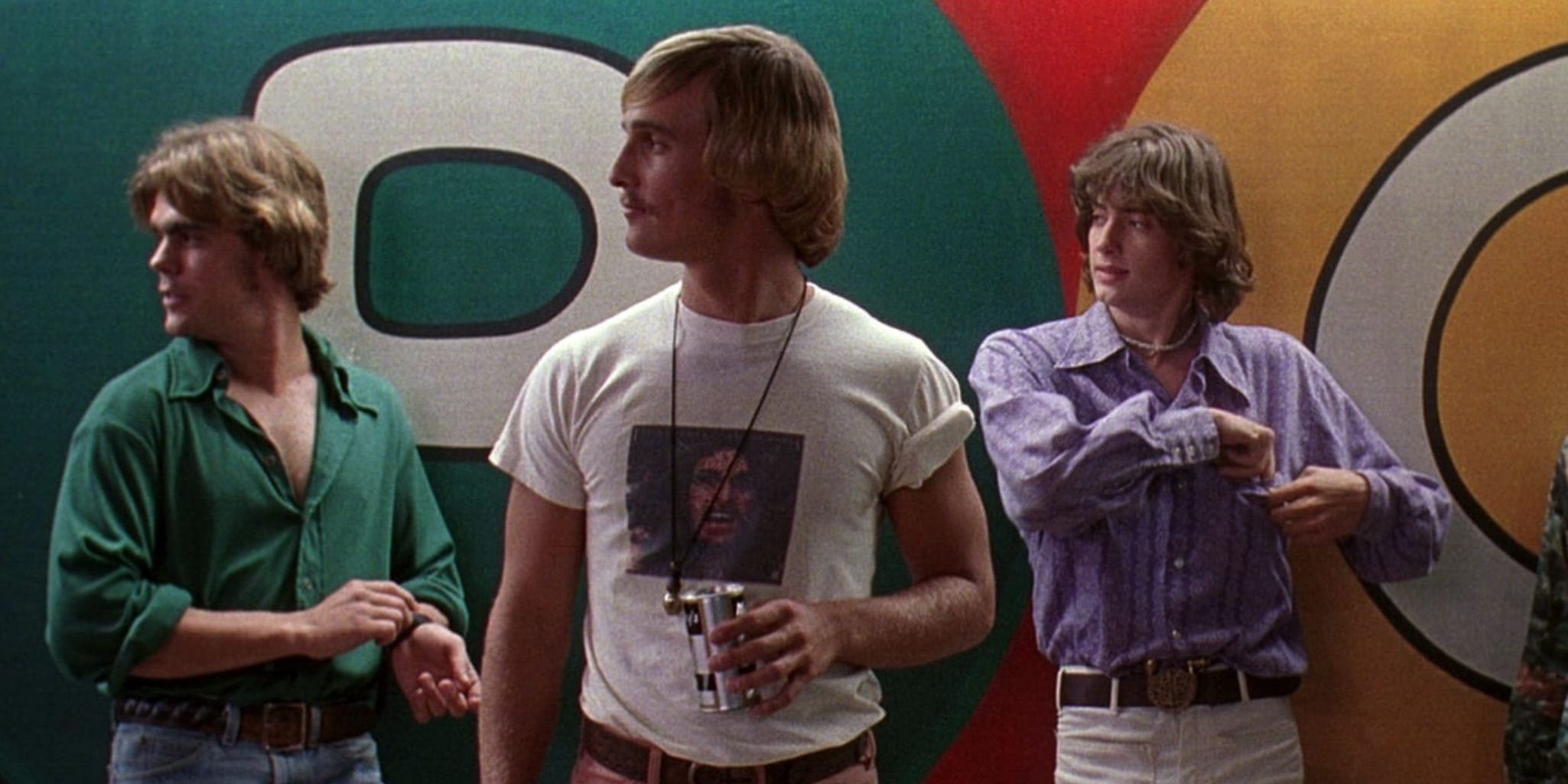 McConaughey and two others looking at someone while standing by a wall in Dazed and Confused