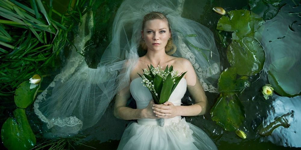 Justine in a wedding dress, lying in greenery in Melancholia