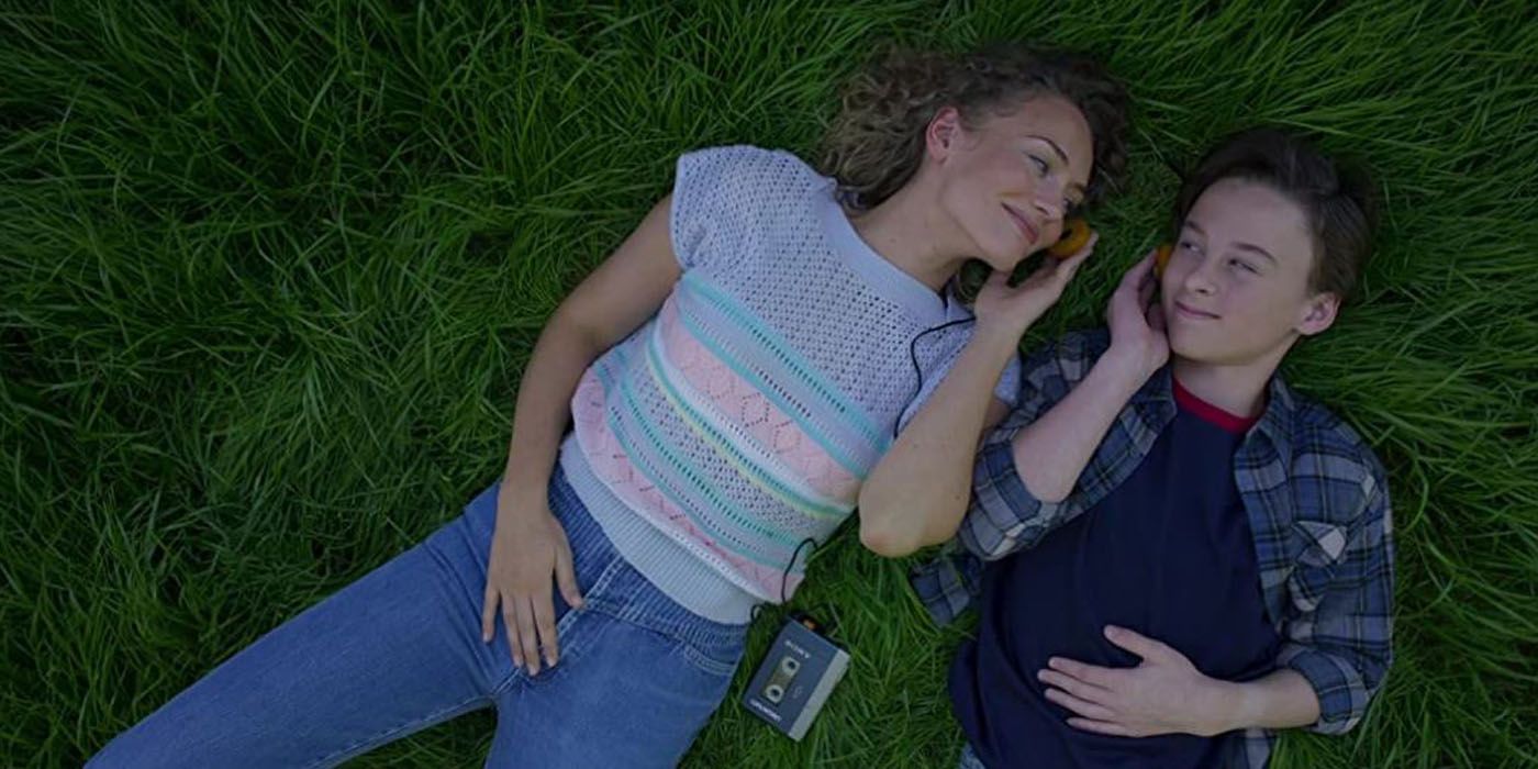 Meredith Quill lying in the grass with a young Peter.