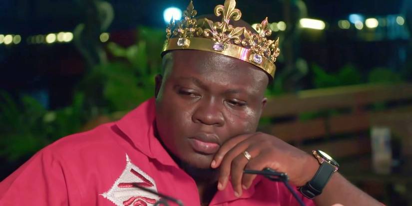 Michael Ilesami In 90 Day Fiance in red shirt wearing crown looking stressed