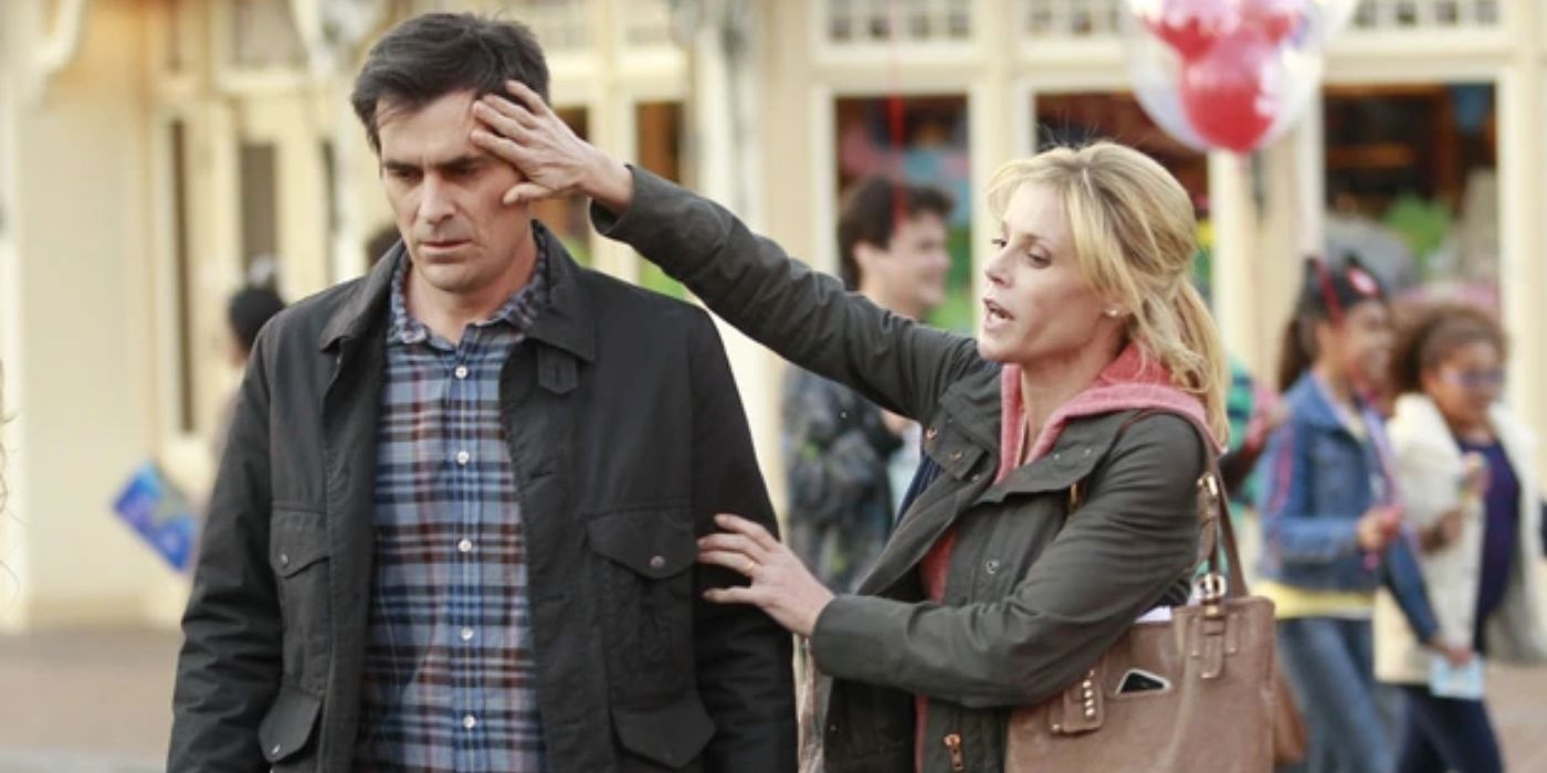 Claire touching Phil's forehead at Disneyland on Modern Family