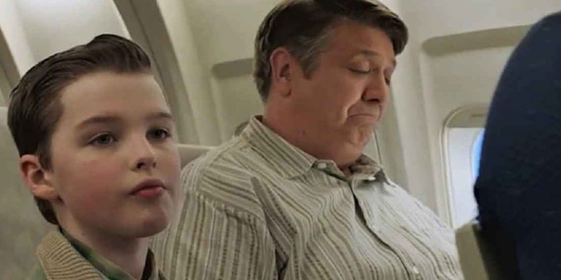 Young Sheldon and his dad fast asleep on a plane ride