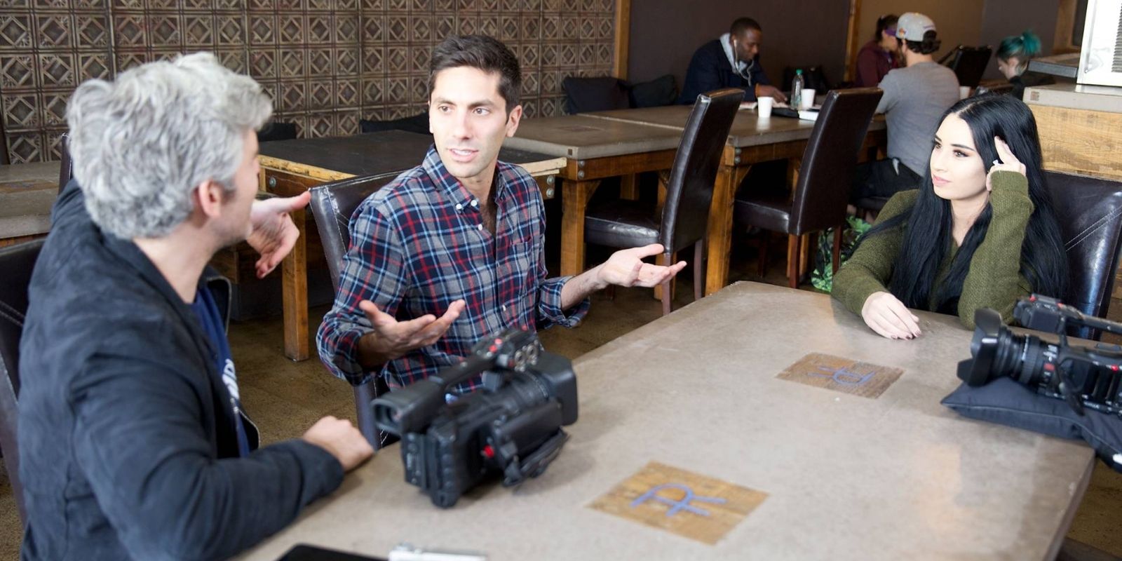 Nev Schulman and Max Joseph sit at the table in discussion in episode Open Investigation of Catfish