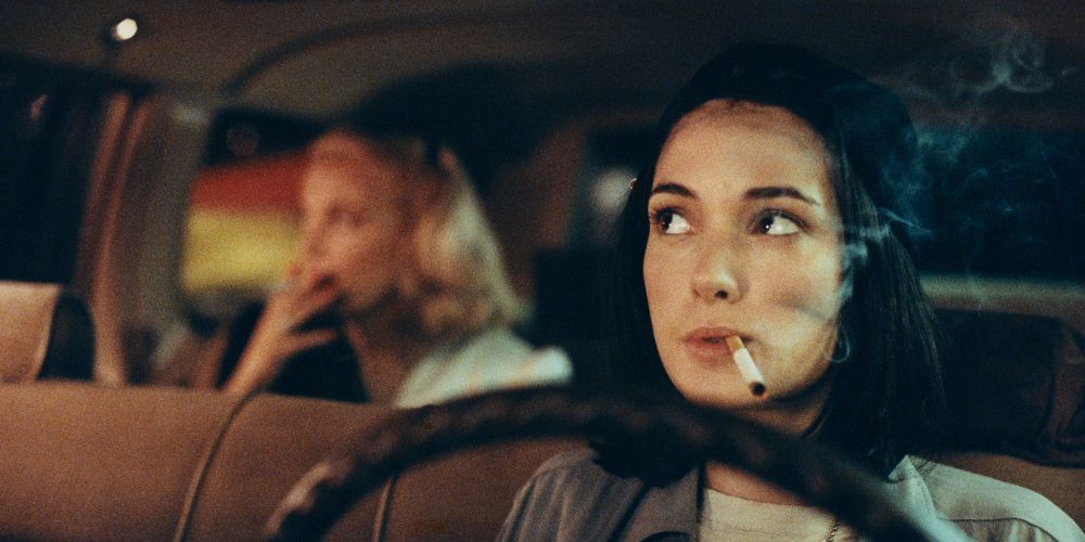 Winona Ryder driving a cab and smoking a cigarette in Night on Earth