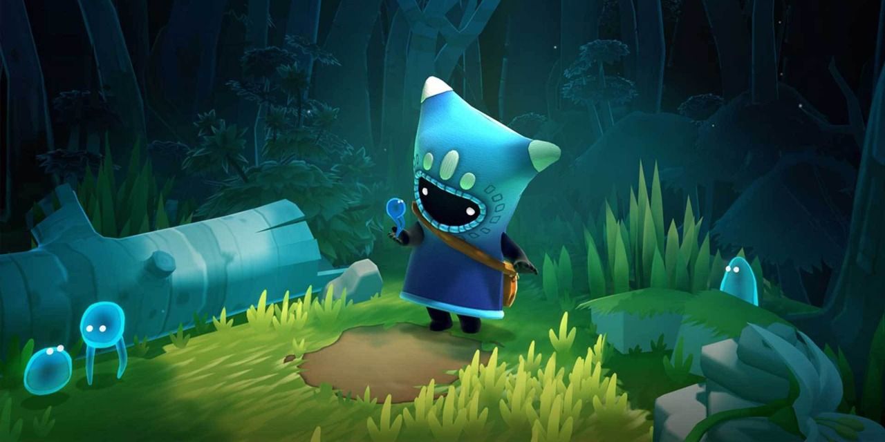 Ember holding a worm-like creature in the forest in The Last Campfire on the Nintendo Switch.