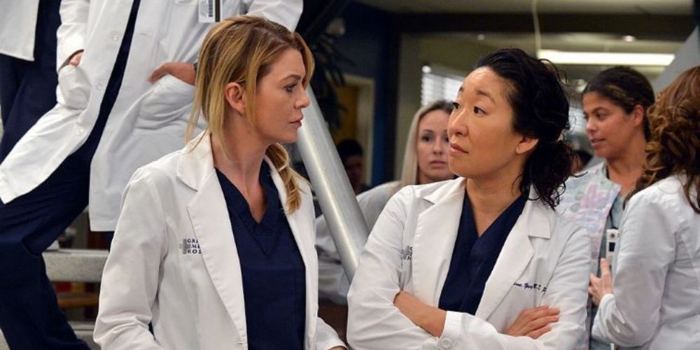 Meredith and Cristina talking in the hospital lobby in Grey's Anatomy