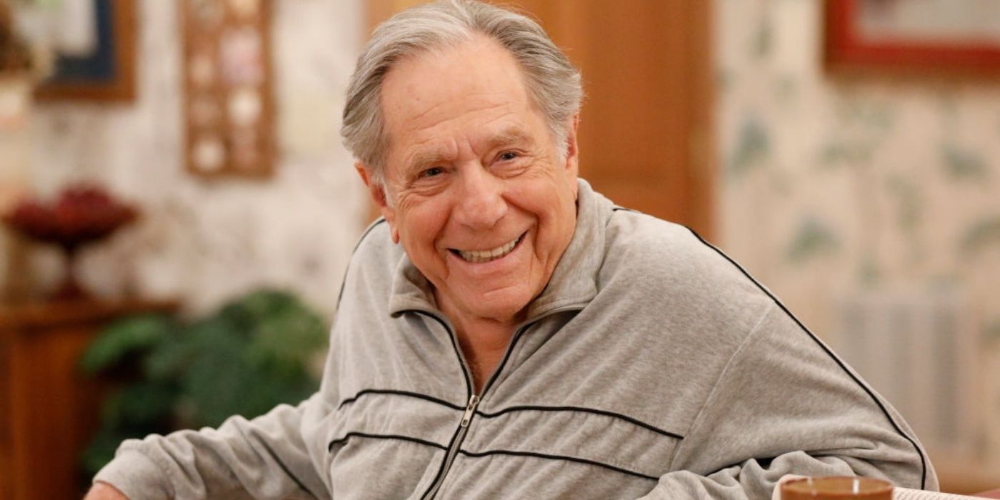George Segal as Pops on set of ABC's The Goldbergs, wearing a gray tracksuit