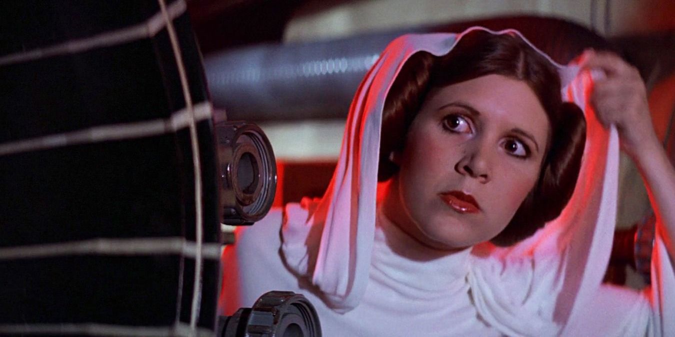 Princess Leia hiding behind a machine with her hood up in Star Wars.