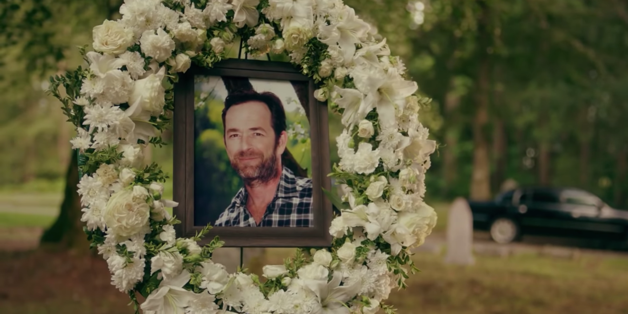 A photo of Fred inside a flower wreath at Fred's funeral