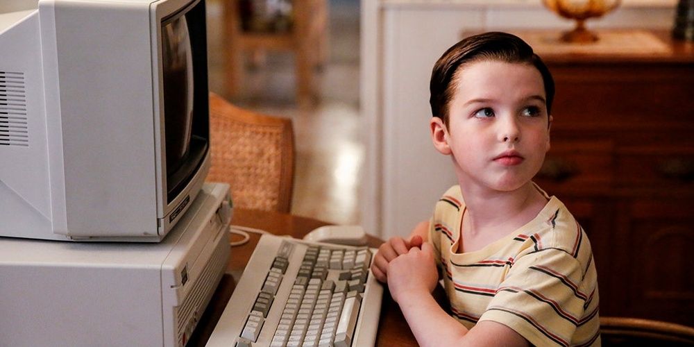 Young Sheldon Cooper using an old computer