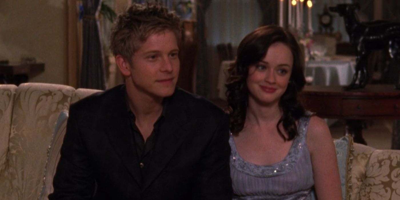 Logan and Rory sitting at the Huntzberger dinner party on Gilmore Girls