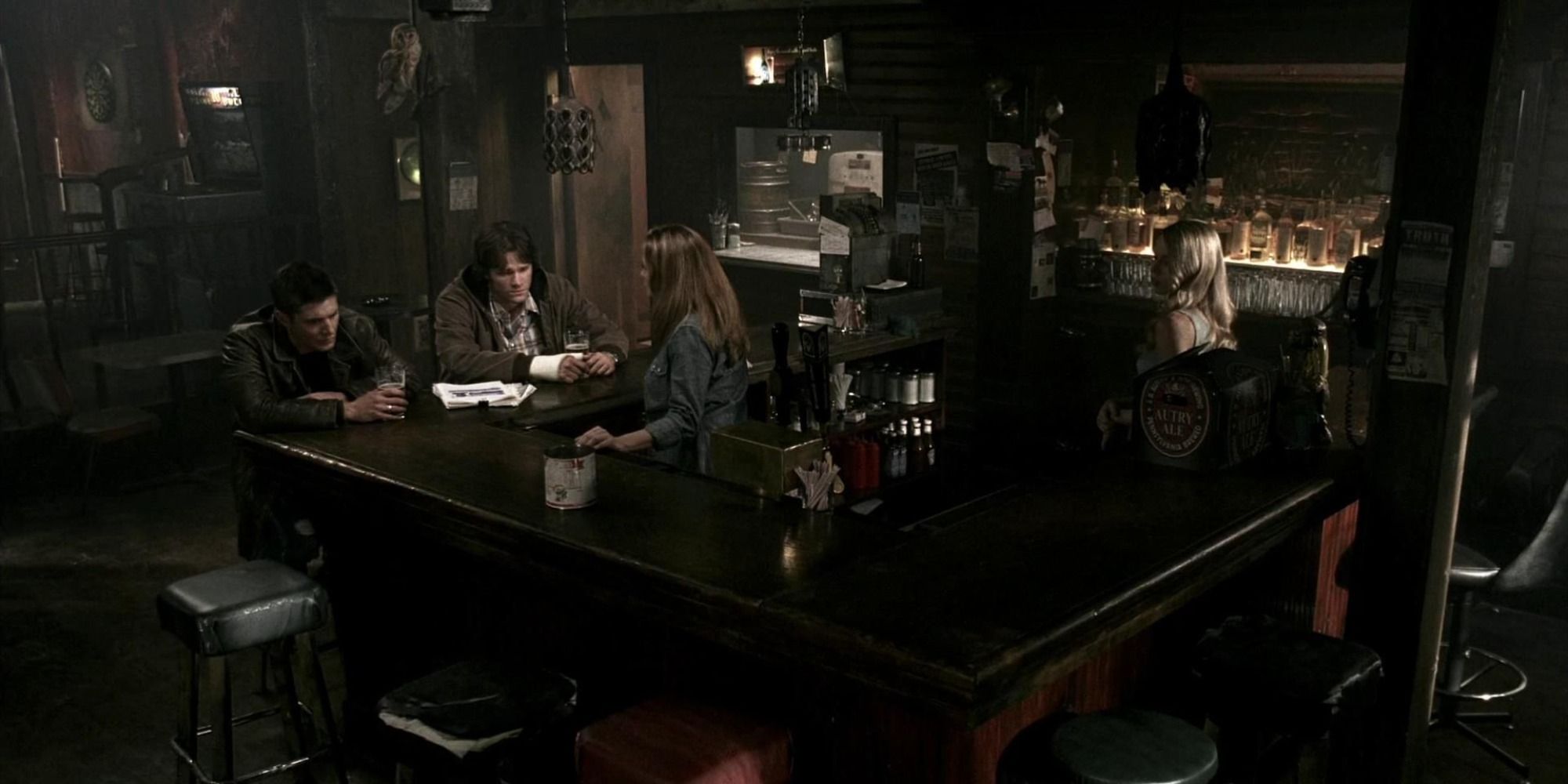 Sam and Dean drinking with Ellen and Jo at the Roadhouse in Supernatural