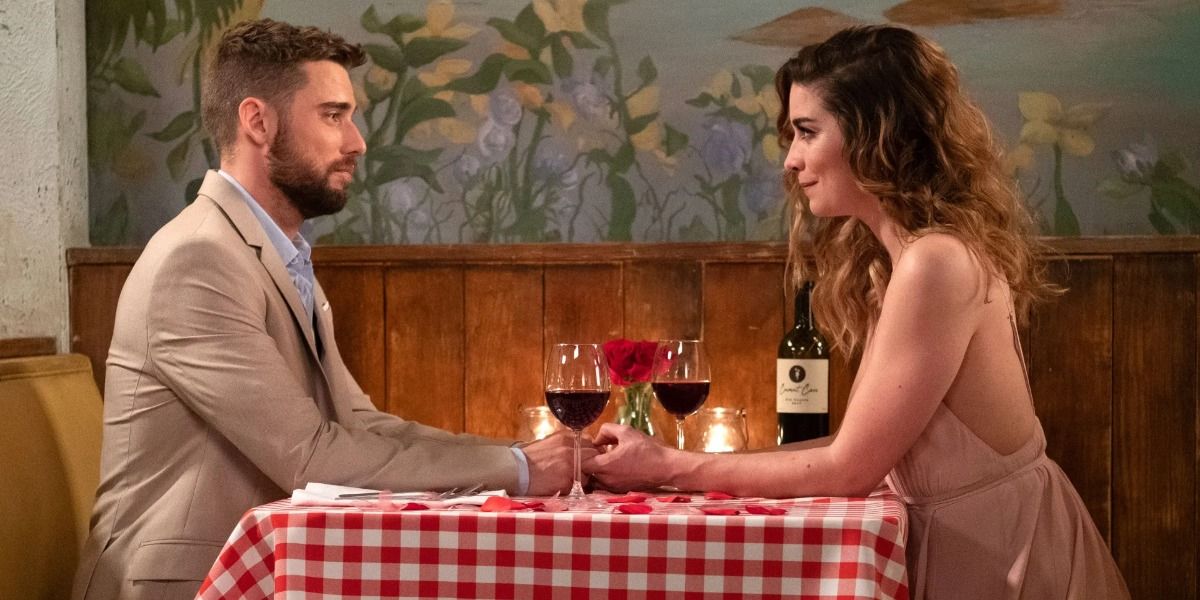 Ted and Alexis sit across from each other at the table in Schitt's Creek