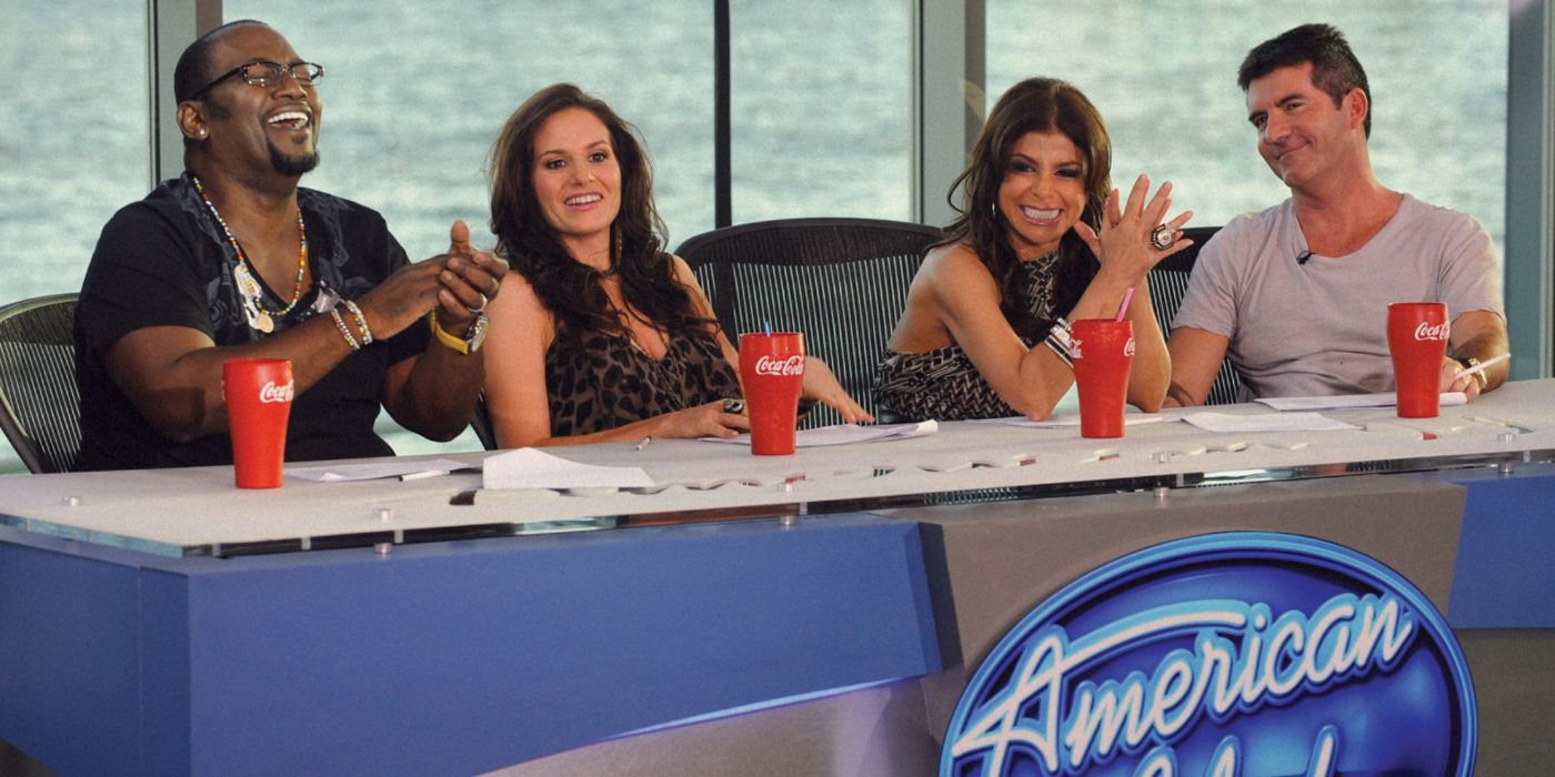 Randy Jackson, Kara DioGuardi, Paula Abdul and Simon Cowell laugh at the American Idol judges table