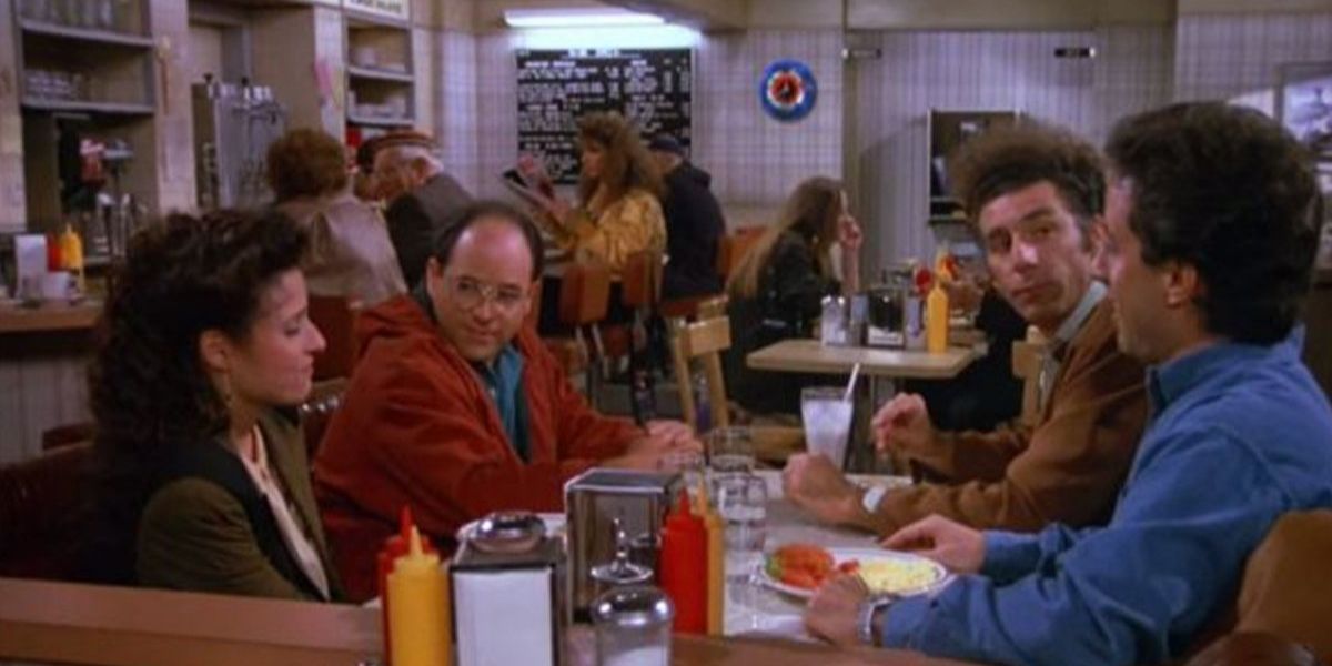 Seinfeld casting sitting at their booth in the diner