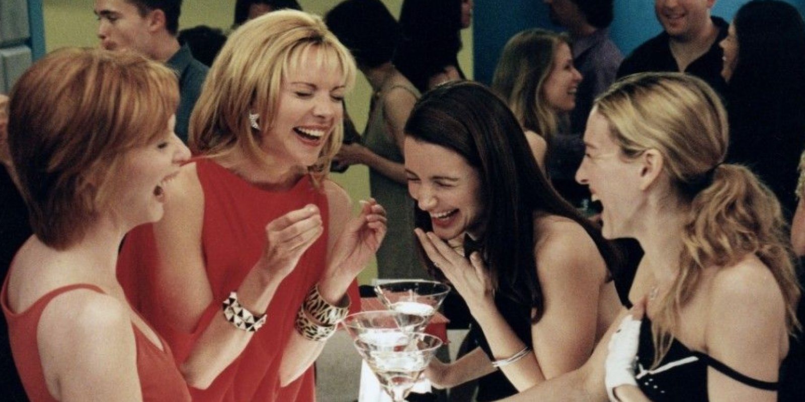 Miranda, Samantha, Charlotte, and Carrie laughing together in Sex and the City