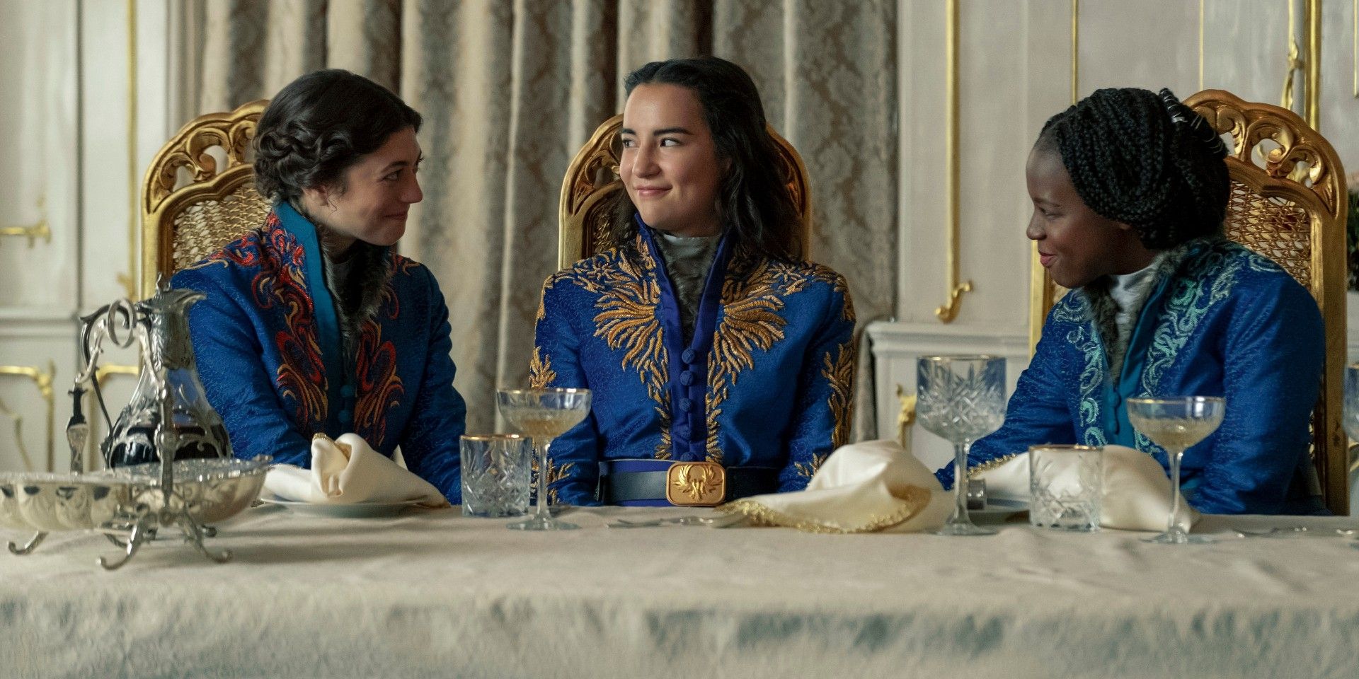 Marie, Alina, and Nadia sitting together in their blue kefta in Shadow and Bone