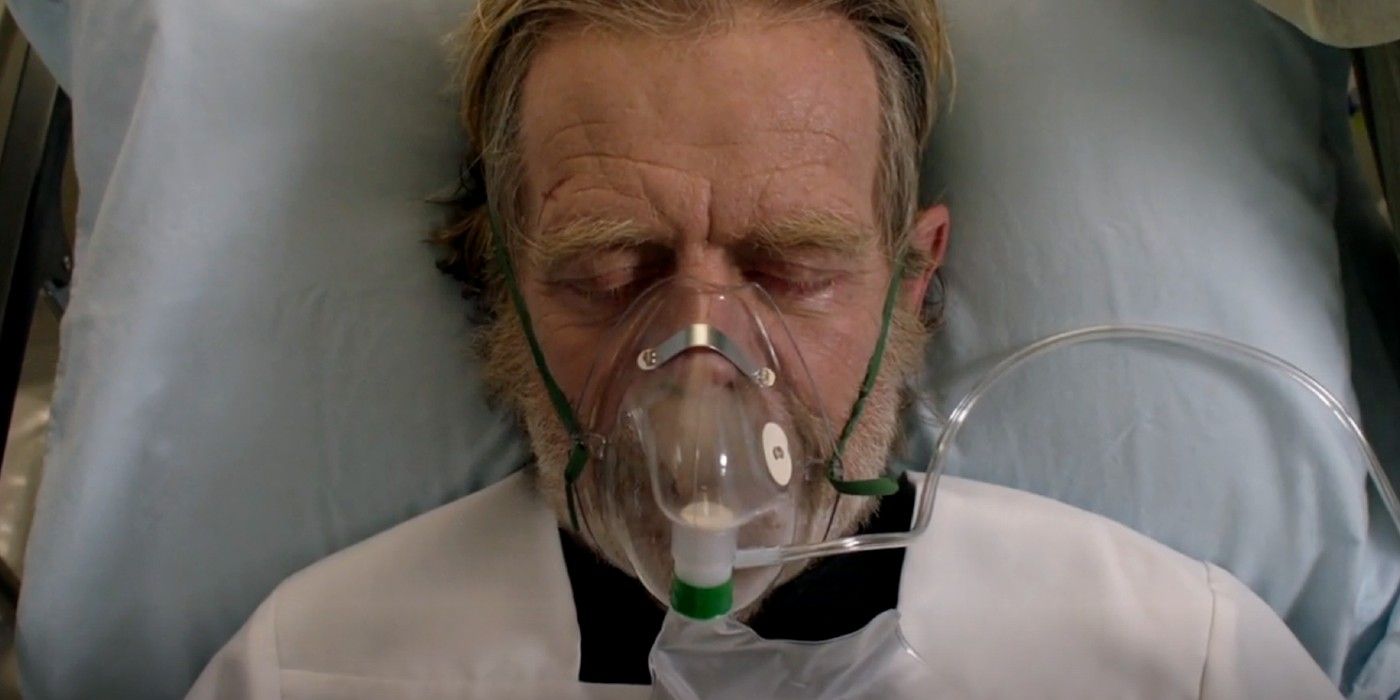 Frank with an oxygen mask on in a hospital bed.