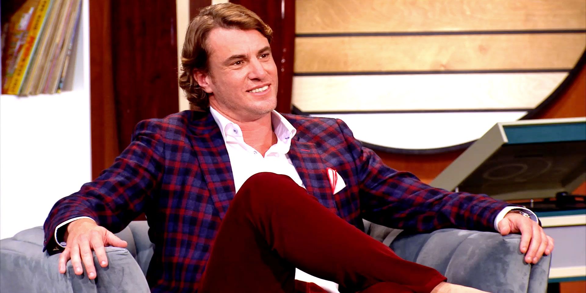 Shep Rose from Southern Charm wearing a plaid suit sitting down