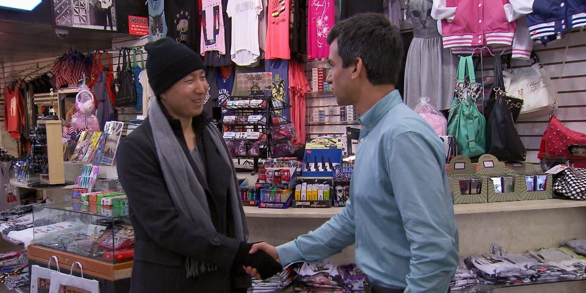 Nathan shaking hands with store owner