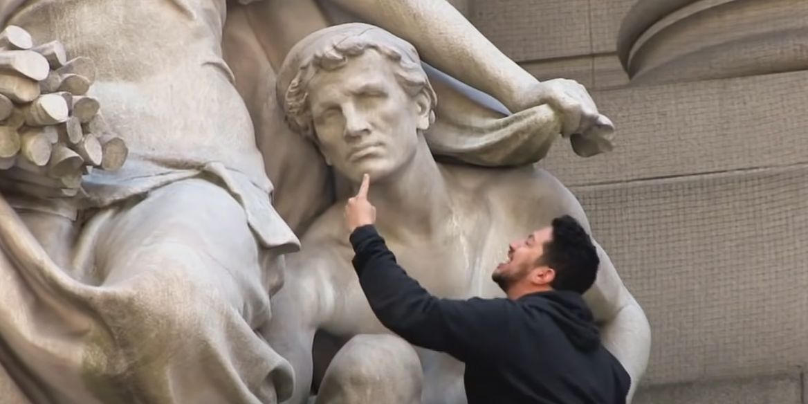 Sal climbs a statue