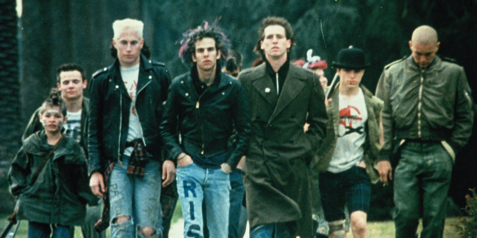 Group of punks walking outside towards the camera in Suburbia