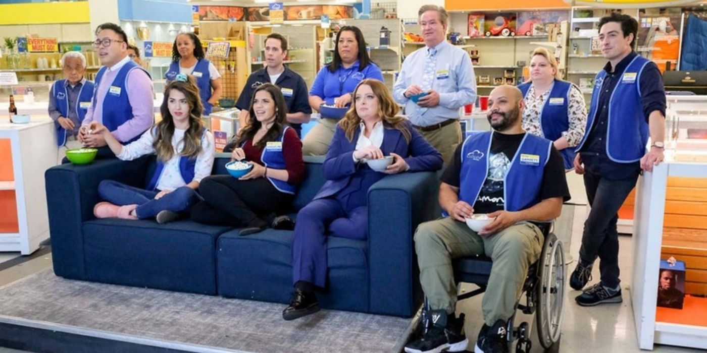 Superstore cast sitting on a coach in Cloud 9 watching a video