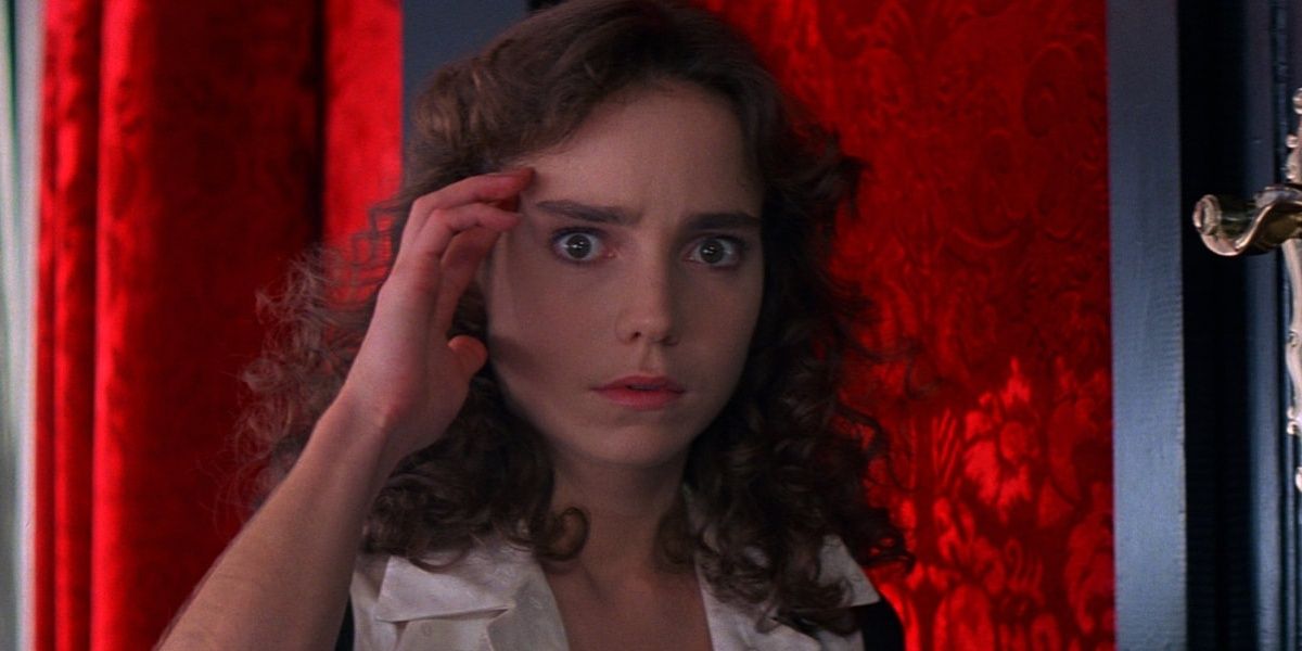 Jessica Harper holds a hand to her temple in 1977's Suspiria