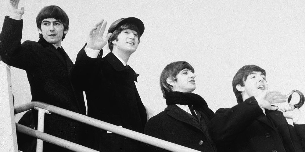 The Beatles arriving in the US, waving to their fans and journalists