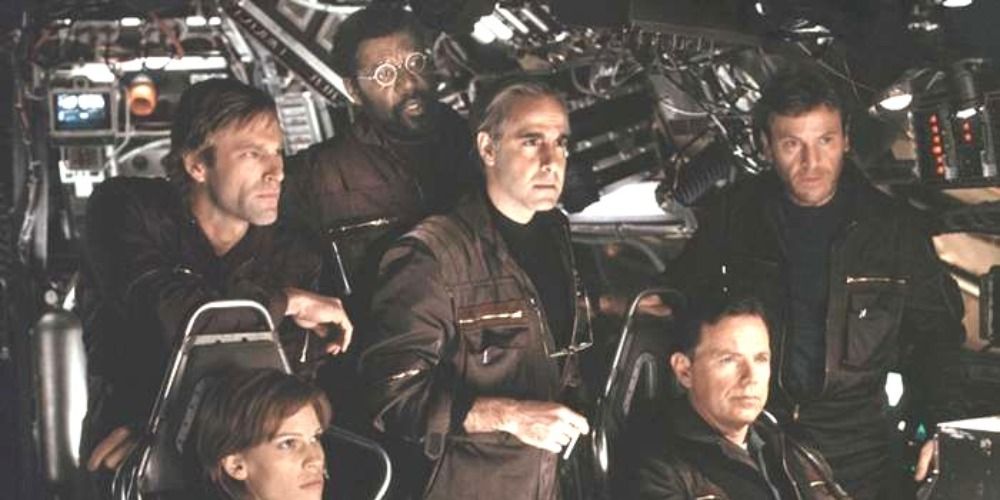 Dave, Paul, Josh, Beck, Zimsky and Richard Iverson sitting in a spaceship in a scene from Landfall