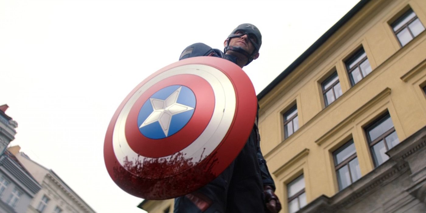 John Walker stands holding Captain America's bloody shield in Falcon And The Winter Soldier.