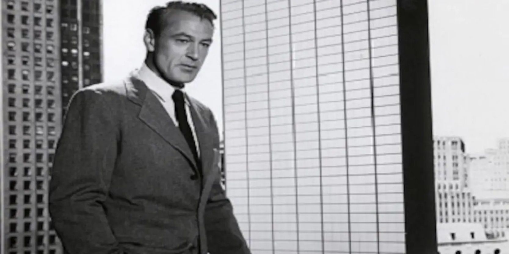 Cary Cooper as Howard Roarke standing in front of building model in The Fountainhead