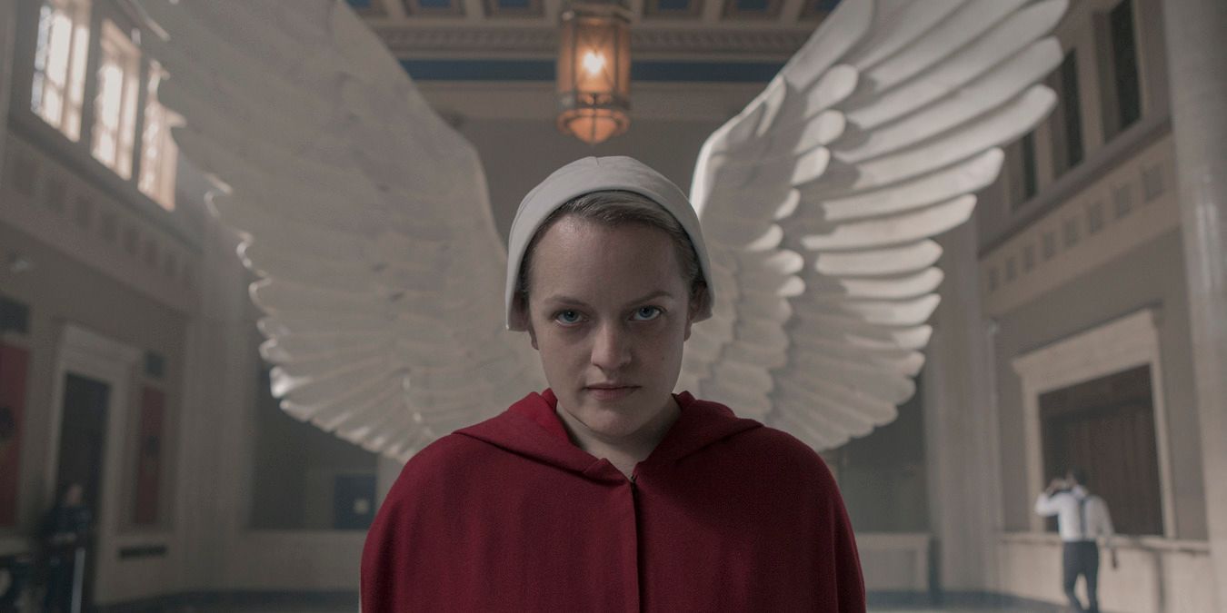 June standing in front of the wings on The Handmaid's Tale 